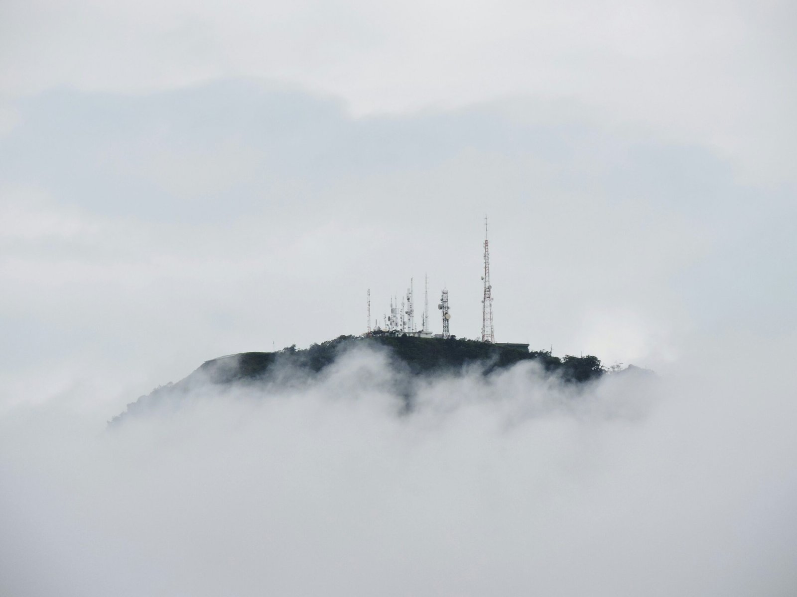 Radio towers on top of a cloud-shrouded mountain in Brazil