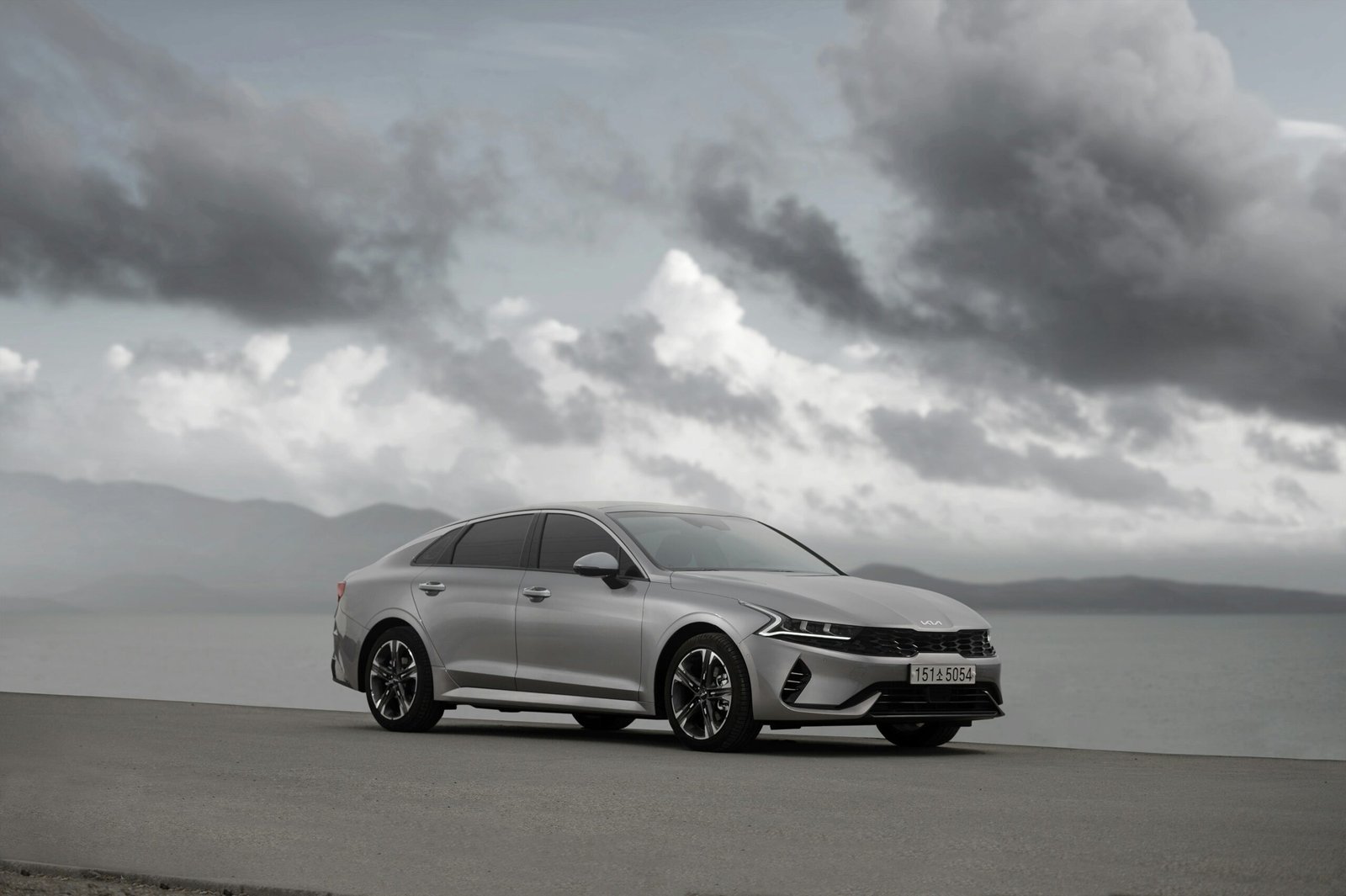 a silver car parked on the side of a road