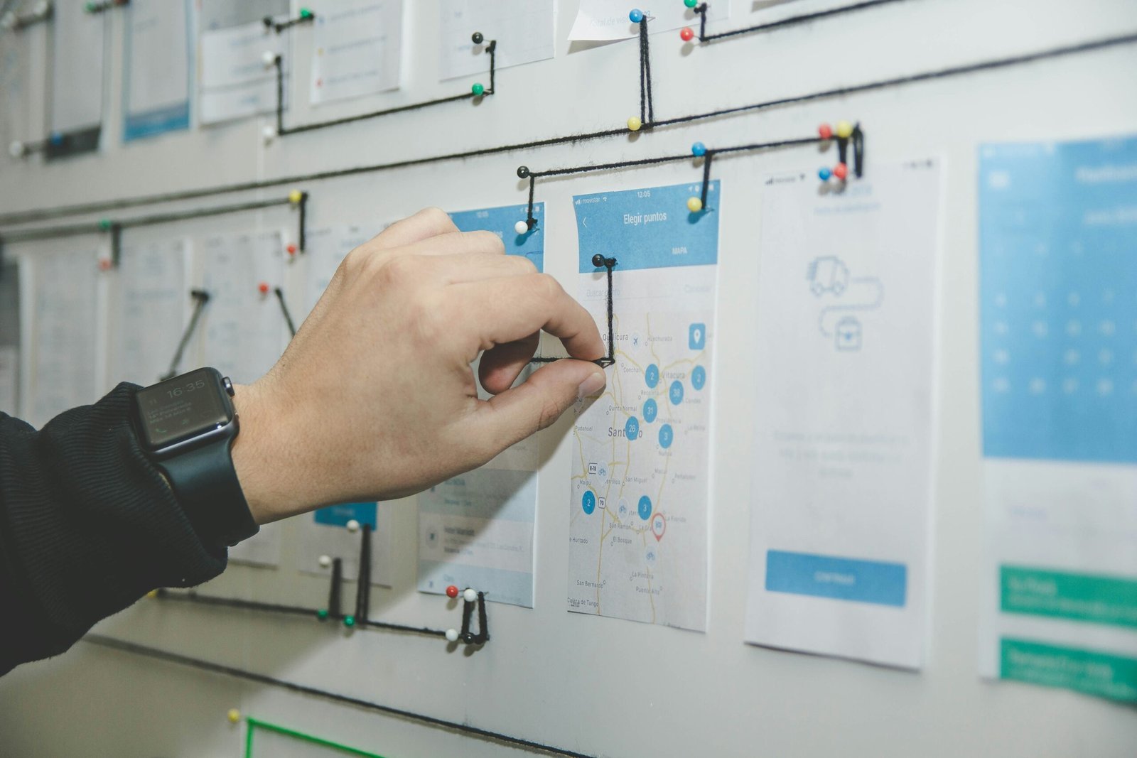 person working on blue and white paper on board